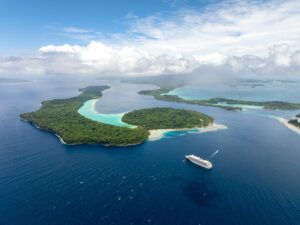 aerial view of cruise ship next to islands