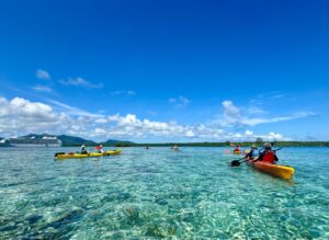 people on kayaks on clear ocean water