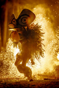 cultural dance in front of bonfire