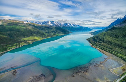 aerial view of a crystal blue lake between land