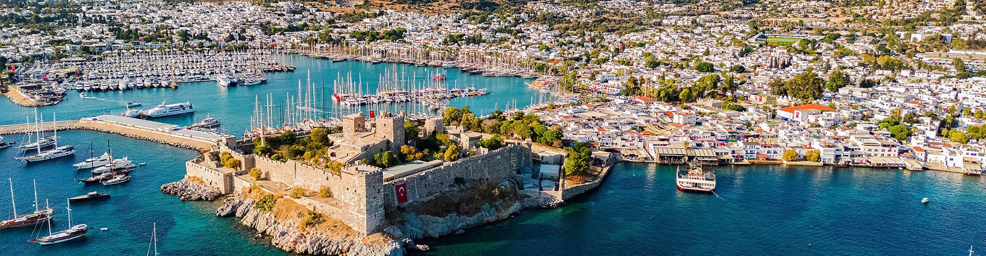 aerial view of a castle on a island next to a port