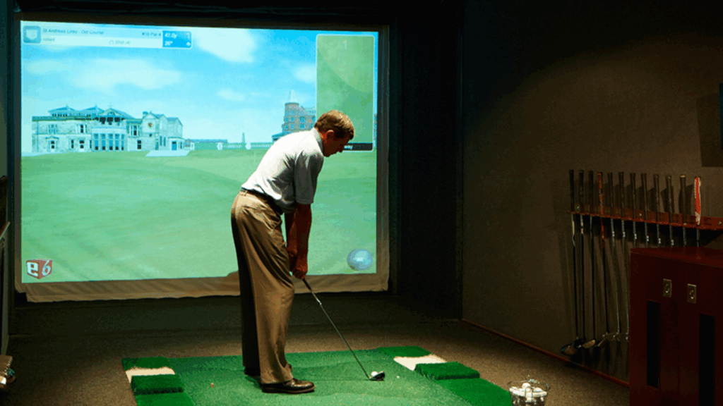 Man playing virtual golf simulator