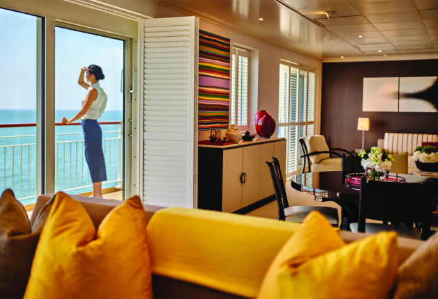 Ship Imagery_Penthouse_Lifestyle_RETOUCHED.jpg Woman looking out at ocean from patio of room